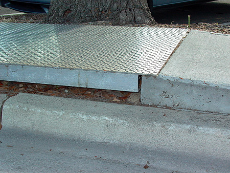 Metal bridging over sidewalk