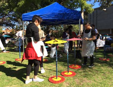  Curtin University students painting paper umbrellas