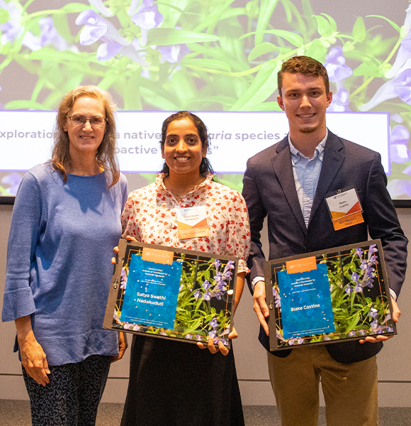 research award. Elaine Turner, Swathi Nadakuduti, and Blake Costine