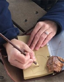 hands draying a leaf, Photo by Carmel, Clay Parks & Recreation